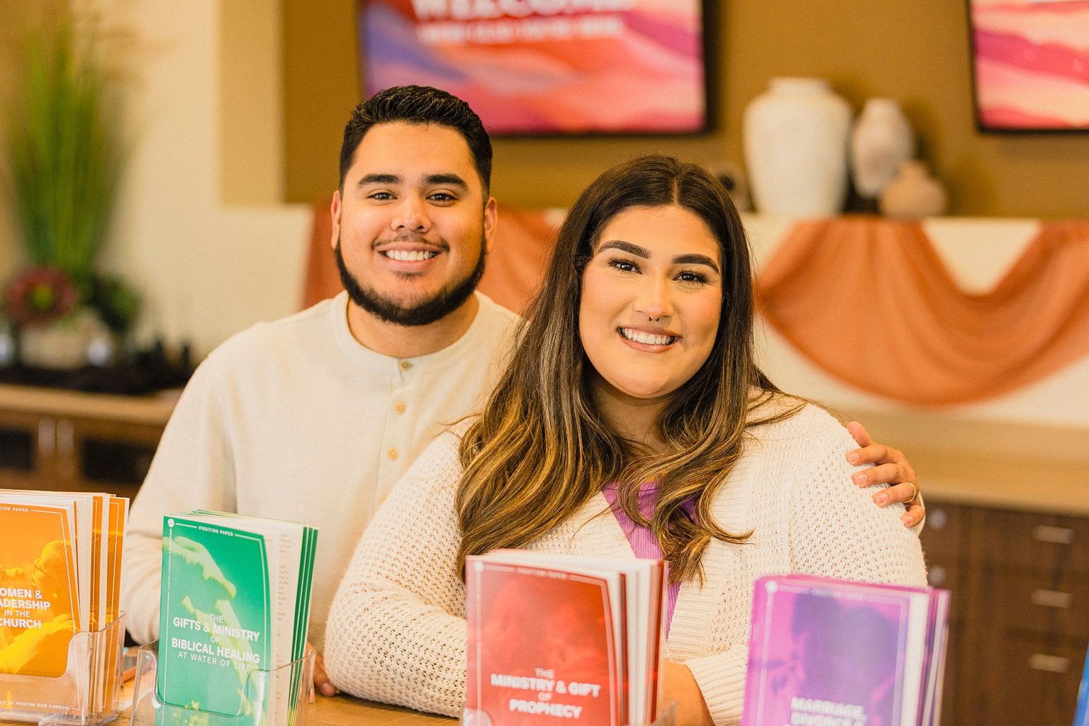 Young couple smiling at the Water of Life welcome table